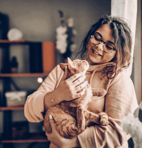 Woman Holding Cat in Hand